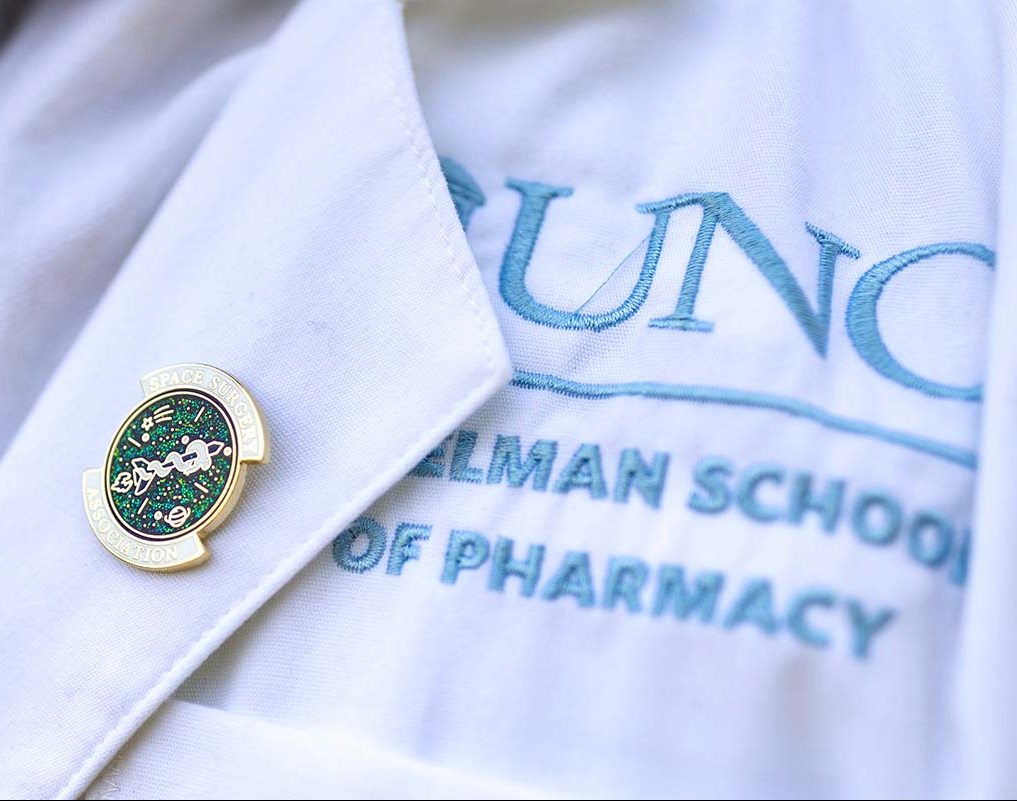 A detail of a button on Tom Diaz's white coat.