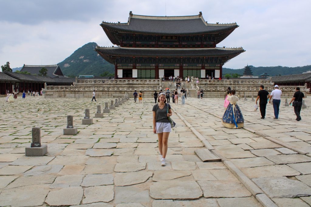 Stroot standing in front of Gyeongbokgung Palace in Seoul, South Korea.