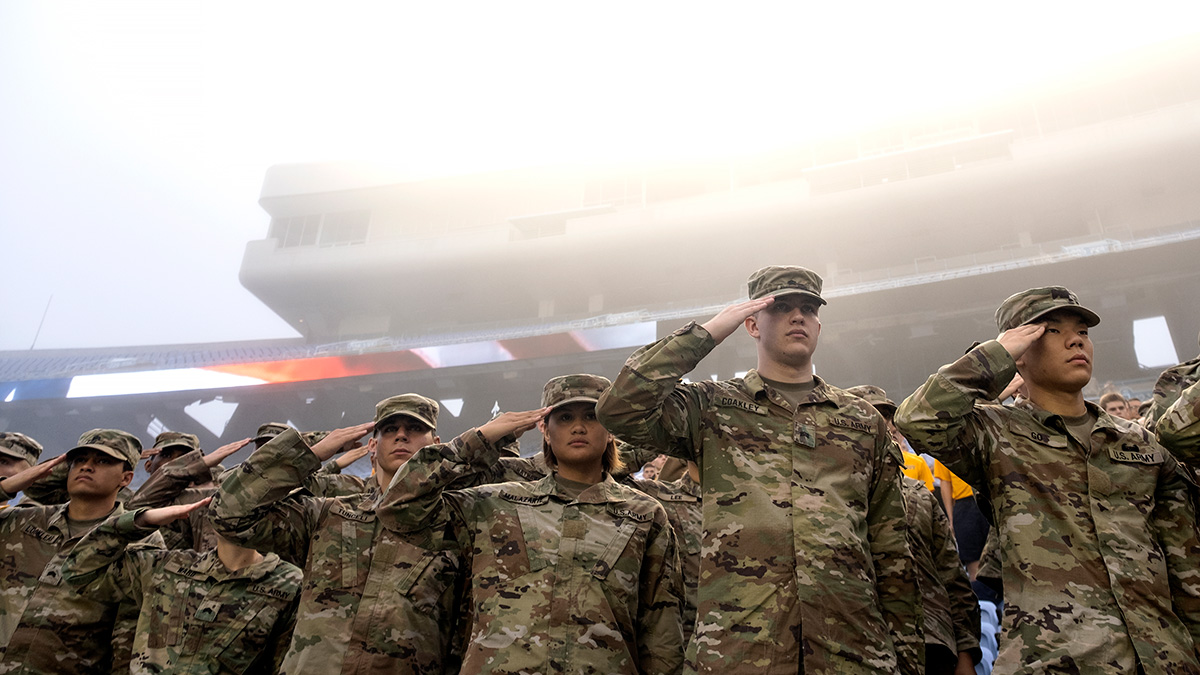 ROTC cadets saluting.