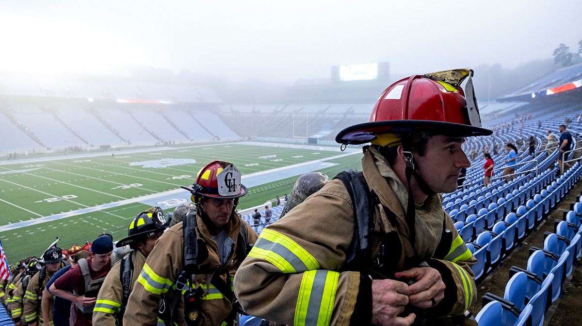 firefighters climb stairs in Kenan Stadium.