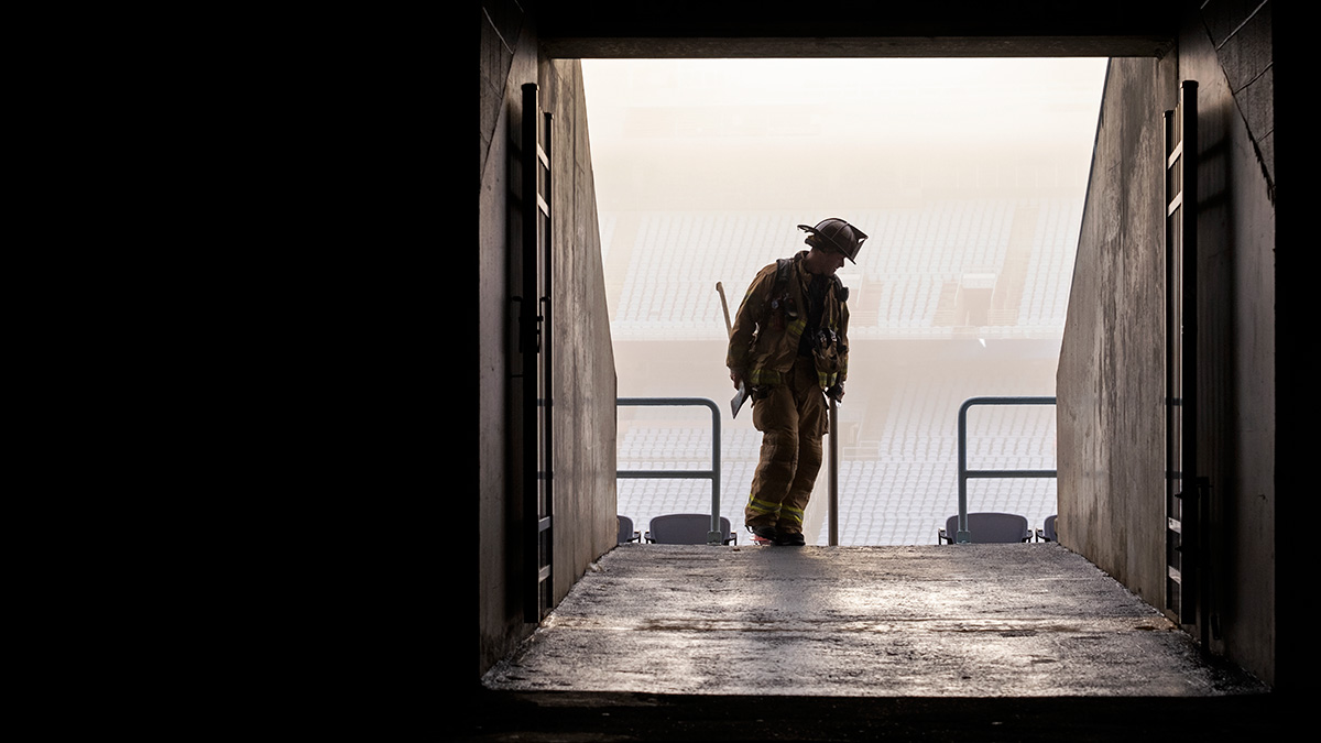 The sillouette of a firefighter at Kenan Stadium.