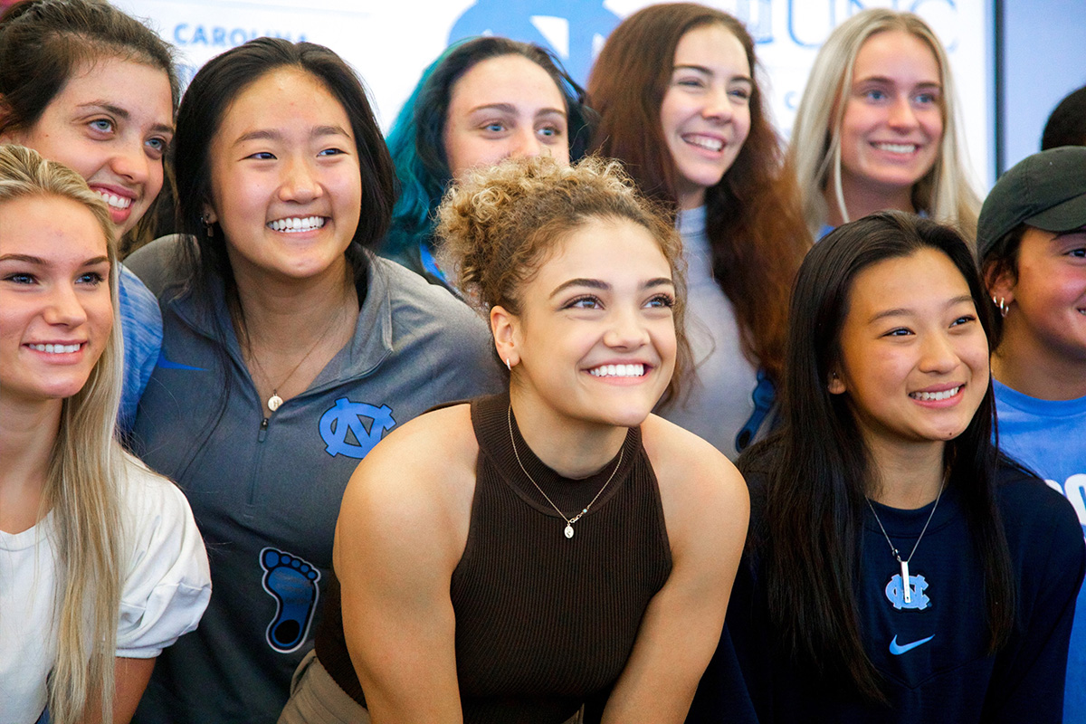 A group pose for a photo with Laurie Hernandez