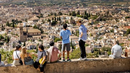 Students stand on a wall in spain.