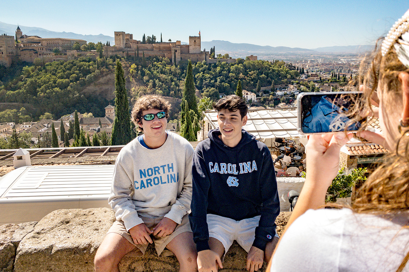 Students sitting on a wall in Spain.