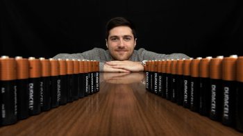 Jack Sundberg sits behind a row of batteries