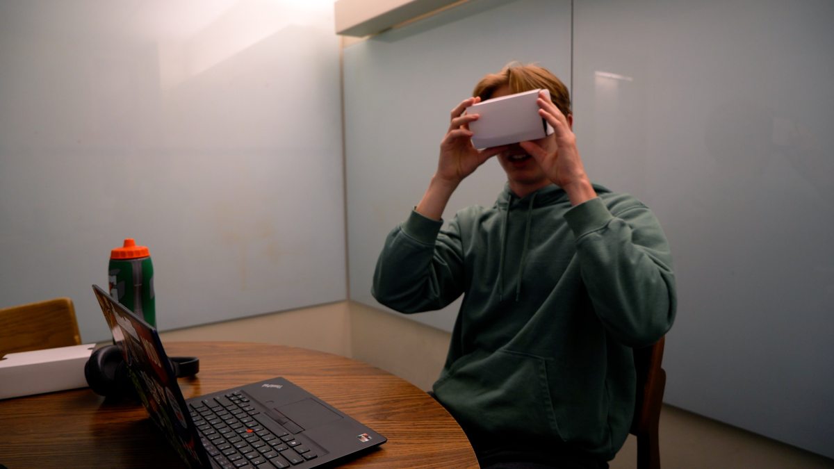 A student looks through a virtual reality viewer.