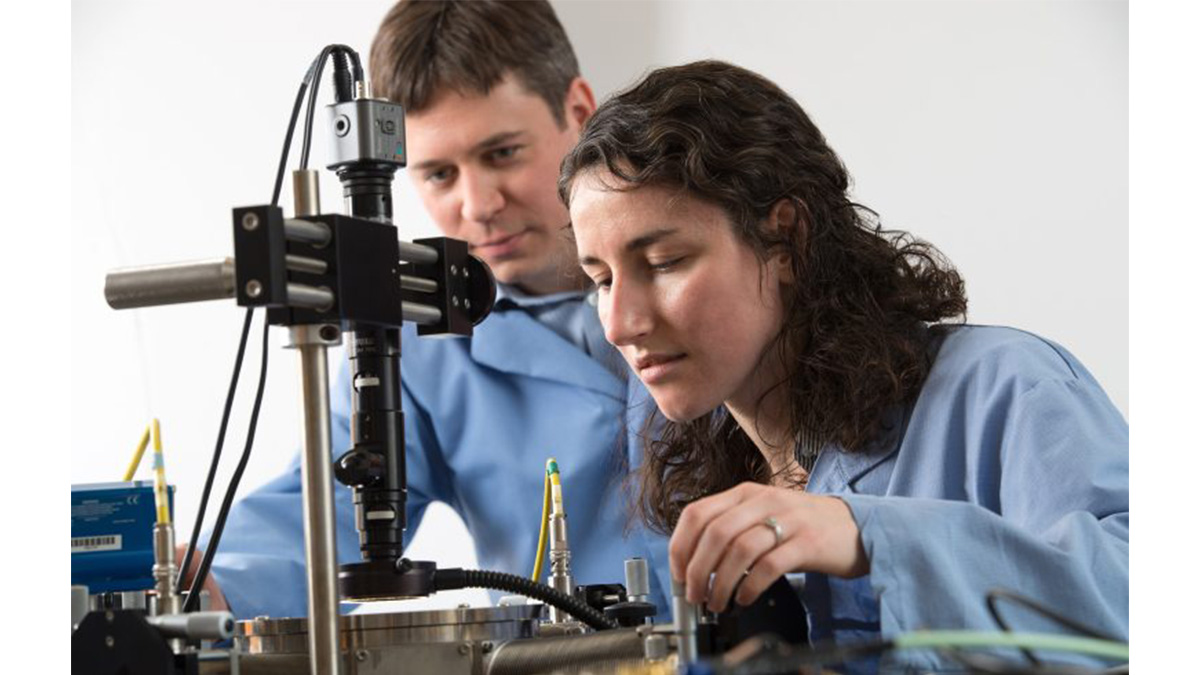 Two students looking at research equipment.