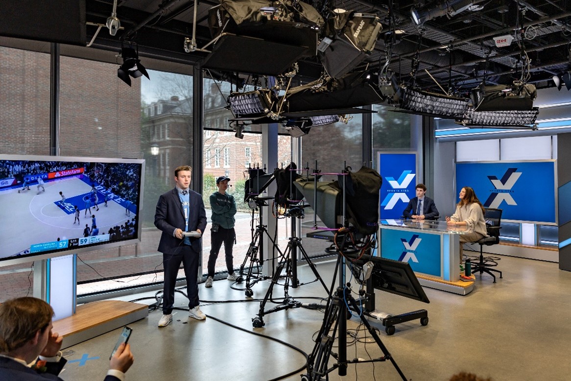 Sports Xtra anchors Joshua Dolgoff and Isabella Geskos and analyst Landon Elliott practice for the show in the broadcast studio of the Curtis Media Center. 
