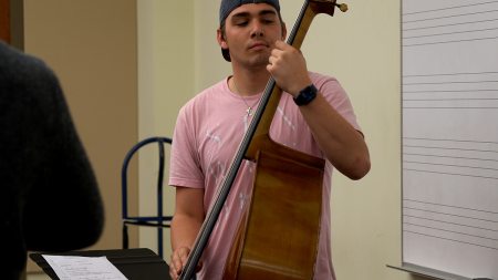 A person holding a string instrument.