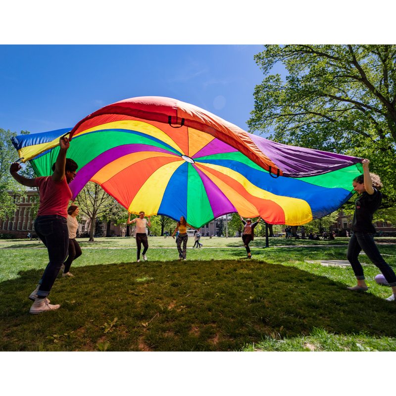 Students with a rainbow parachute.