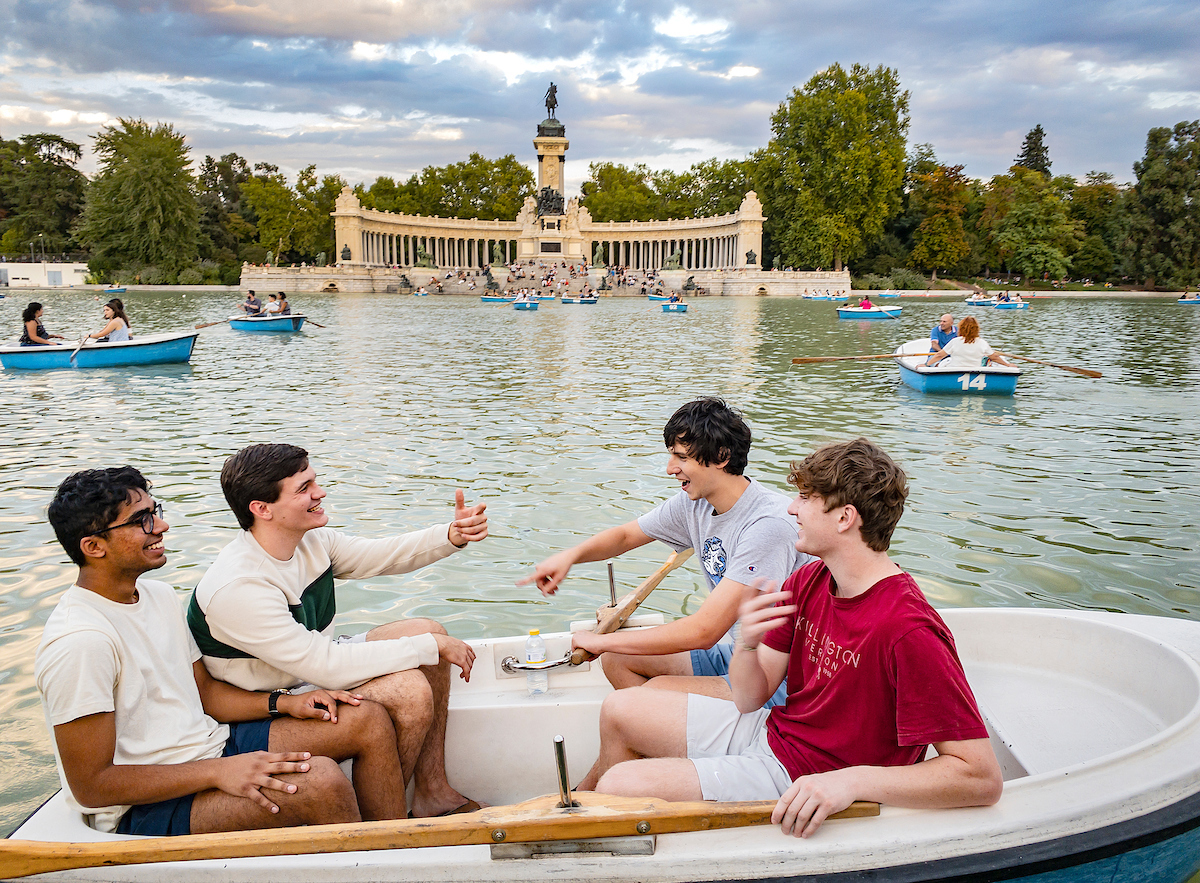 Four students sitting in a row boat.