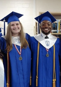 Kacie and Deandre in a blue cap and gown.