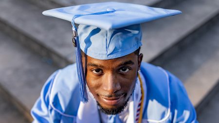 A UNC graduate poses for a photo.