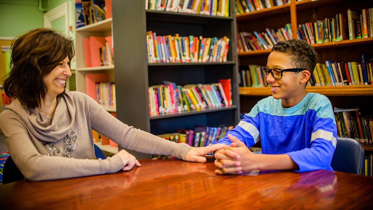 A school counselor talking with a student.