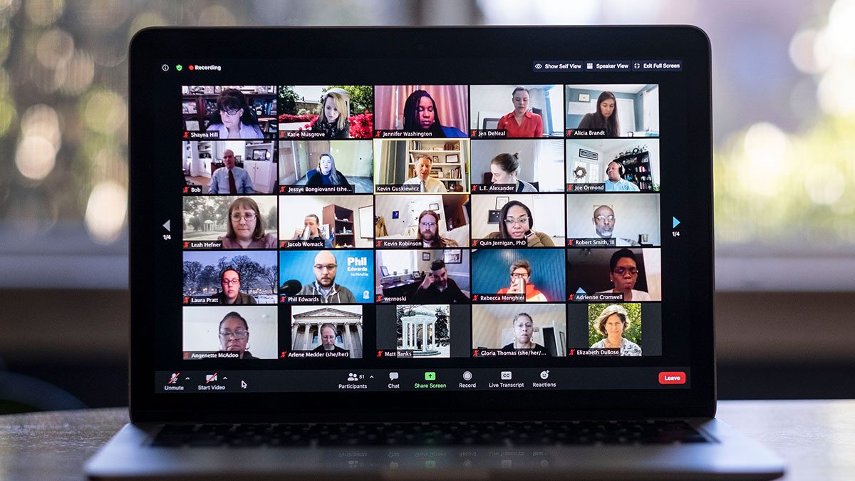 Computer screen with lots of small images of people in a Zoom meeting