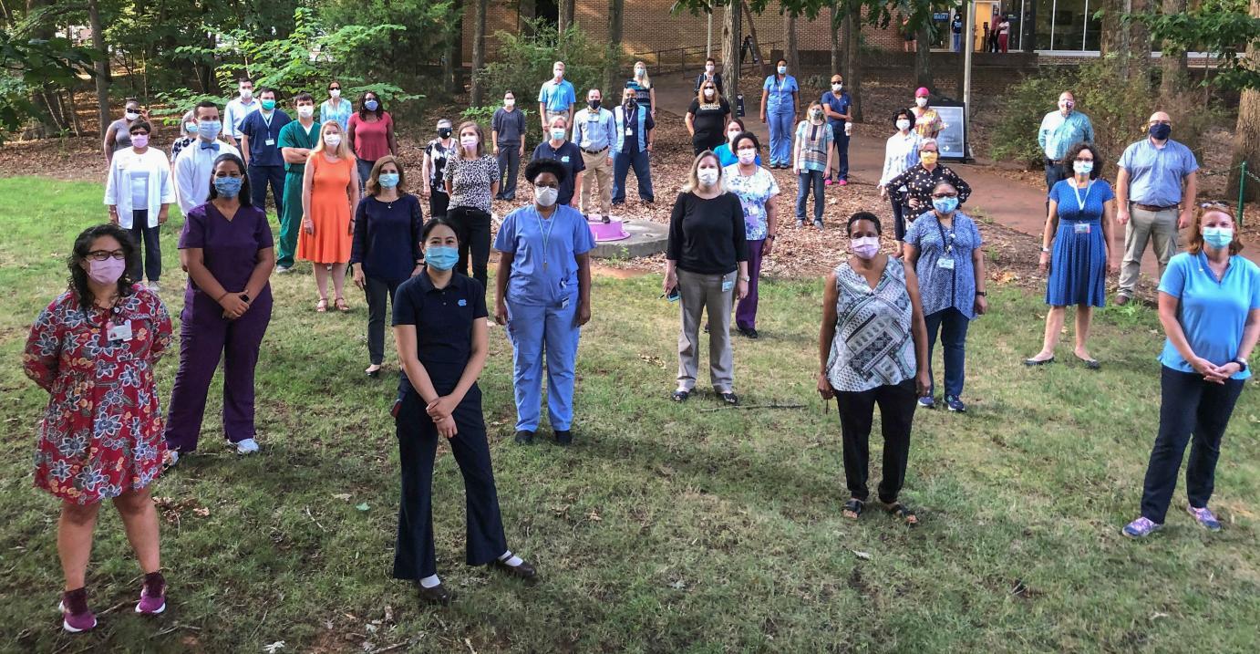 Campus Health employees in PPE gathered outside the James A. Taylor Building, home of Campus Health (Image courtesy of Campus Health)