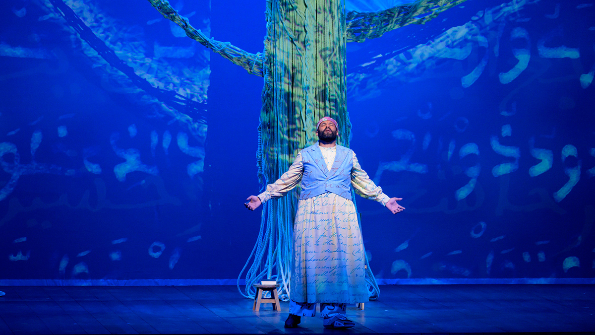 An actor playing the role of Omar Ibn Said and singing on stage in the opera "Omar."