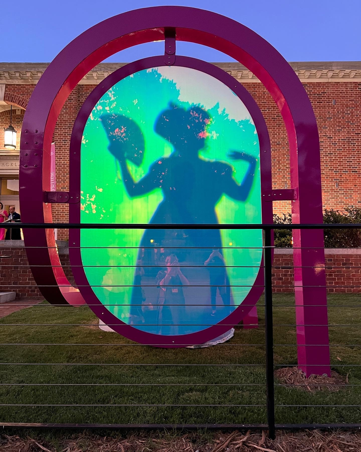 A participant poses behind an art installation outside the Ackland Art Museum during the mystery event.