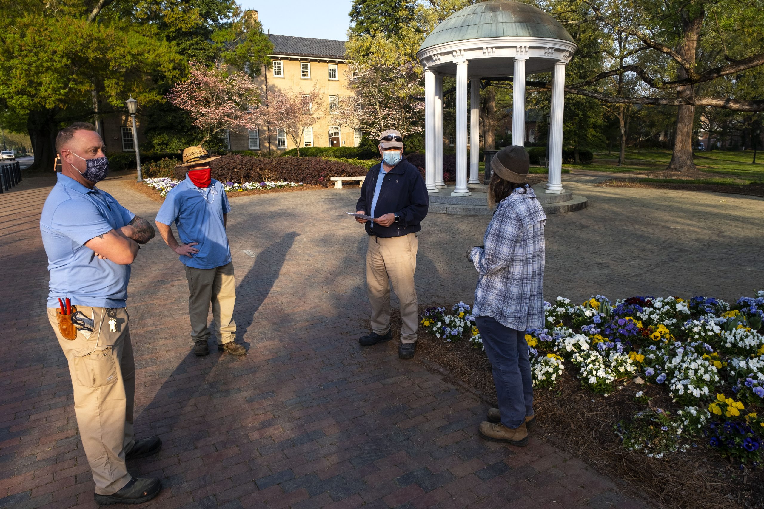 Peter Ampuja, second from right, checks in with the three crew members, left to right, Eric Tolar, Ryan Talley and Krystal King.They had similar meetings at 7 a.m. every day while they were the only groundskeepers working in the historic campus area. “During the pandemic the pace of the life changed but the beauty of campus didn't,” Ampuja said. “We continued providing a place for the community to enjoy, and campus visitors appreciate the hard work that Grounds crews put in ast spring. It was nice to have people sometimes stop to say ‘thank you’ to the crew.”