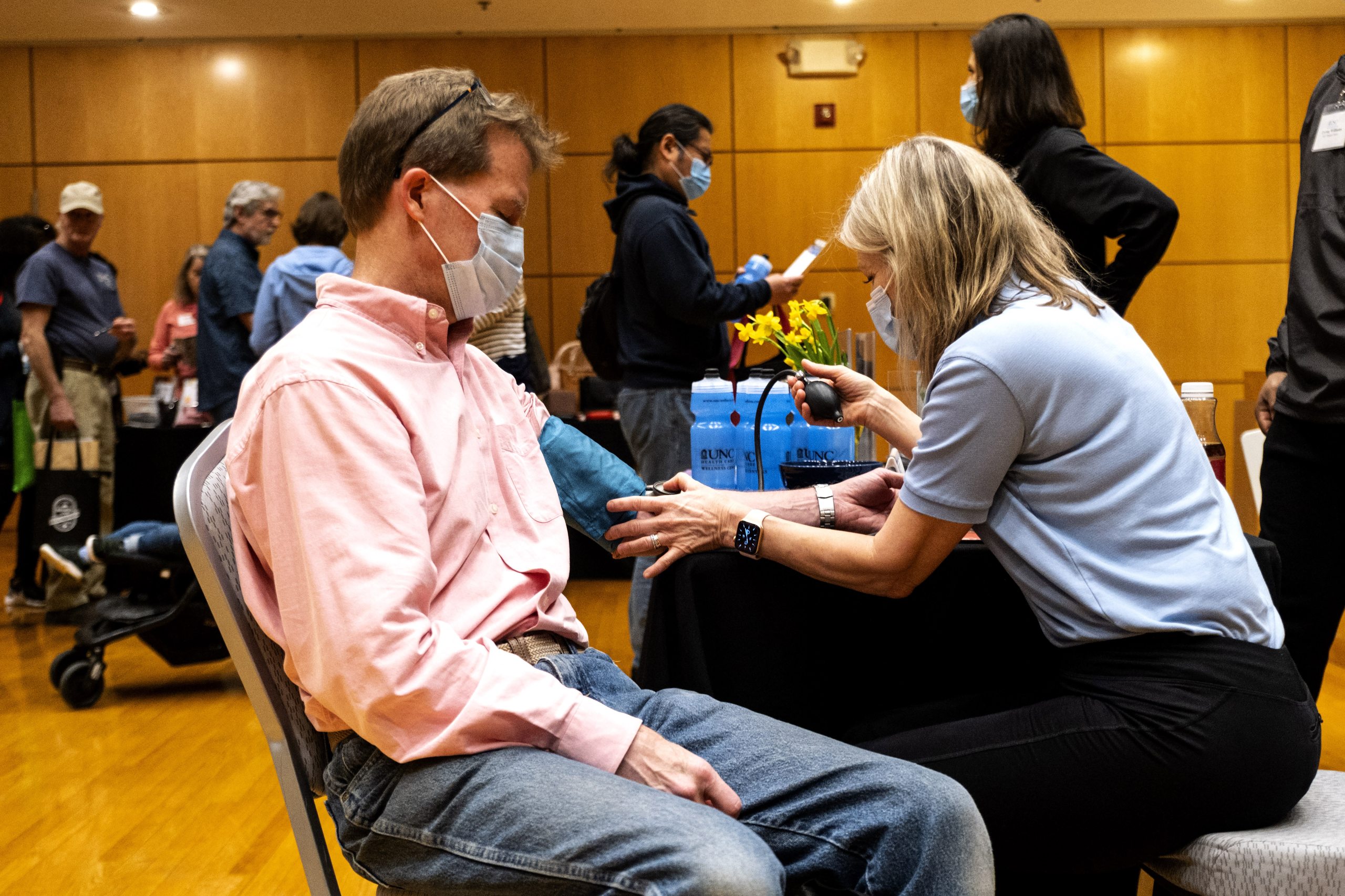 Susan Chesser of the UNC Wellness Center checks the blood pressure of Brian Sturm.