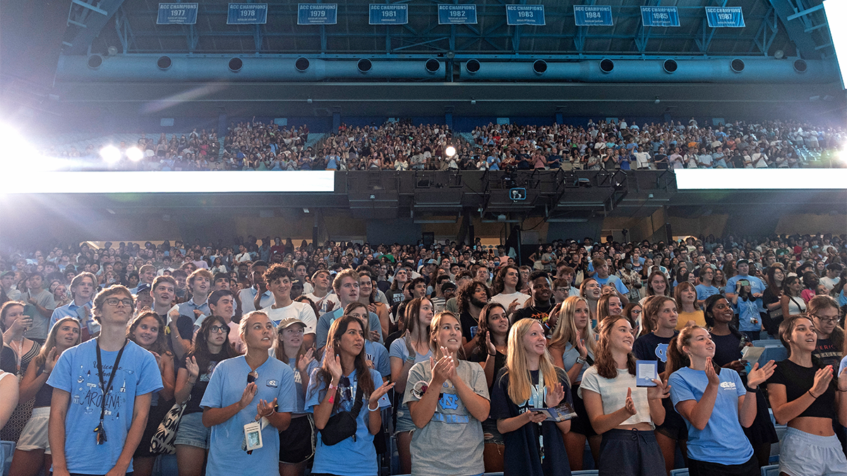 A crowd of students standing in an arena.