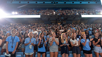A crowd of students standing in an arena.