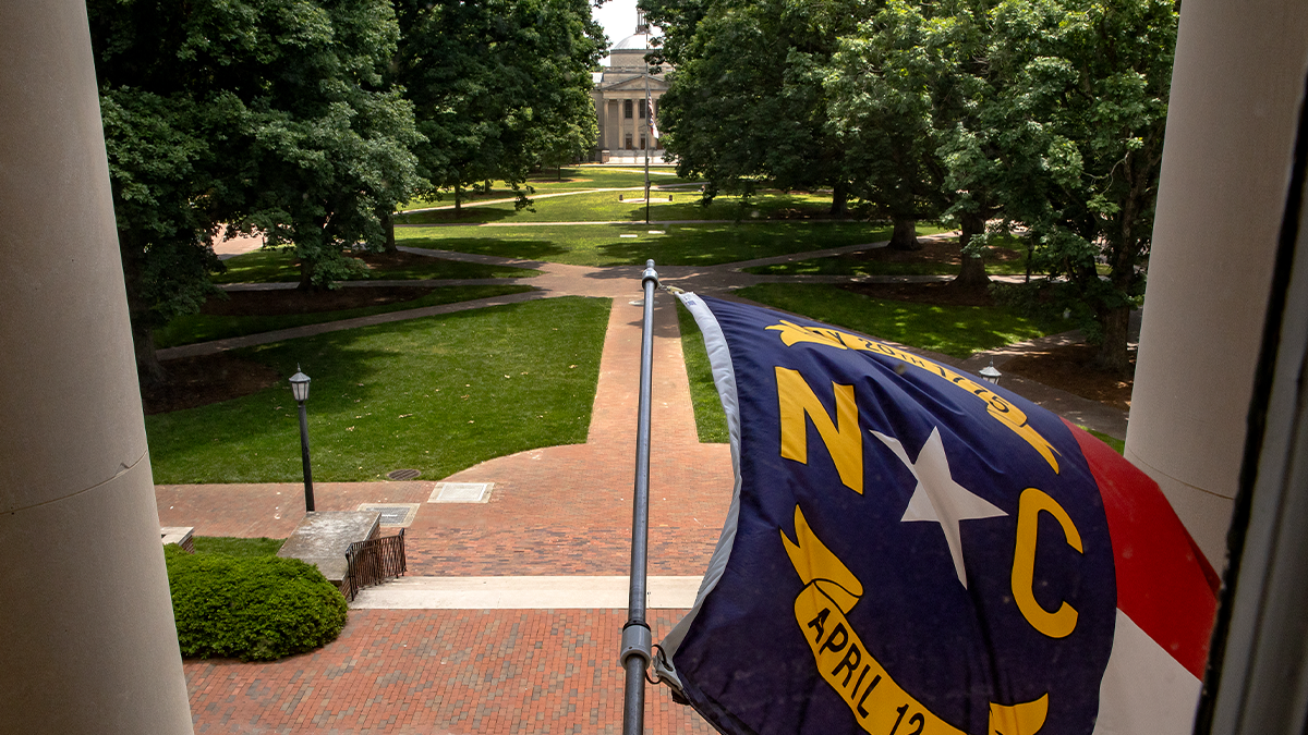 North Carolina state flag flying outside of South Building on the campus of UNC-Chapel HIll.