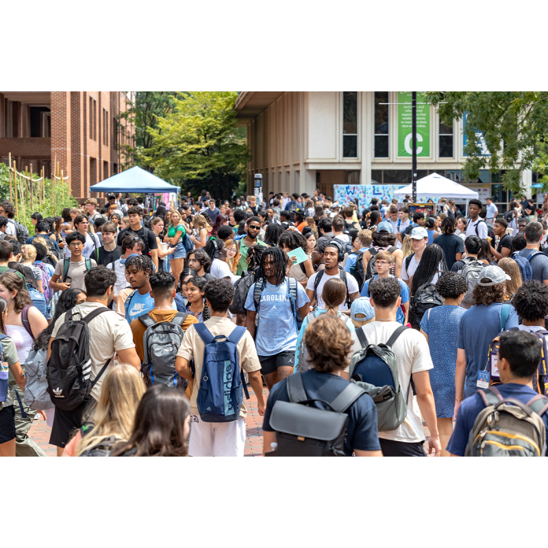 A large crowd of students on the campus of UNC-Chapel Hill near a popular student hangout called 