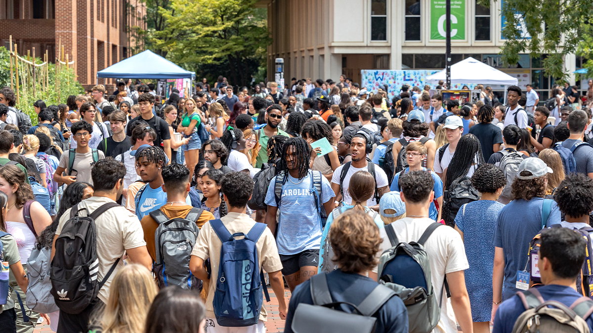 A large crowd of students on the campus of UNC-Chapel Hill near a popular student hangout called 