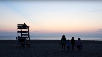 Macio family on the beach at sunset.