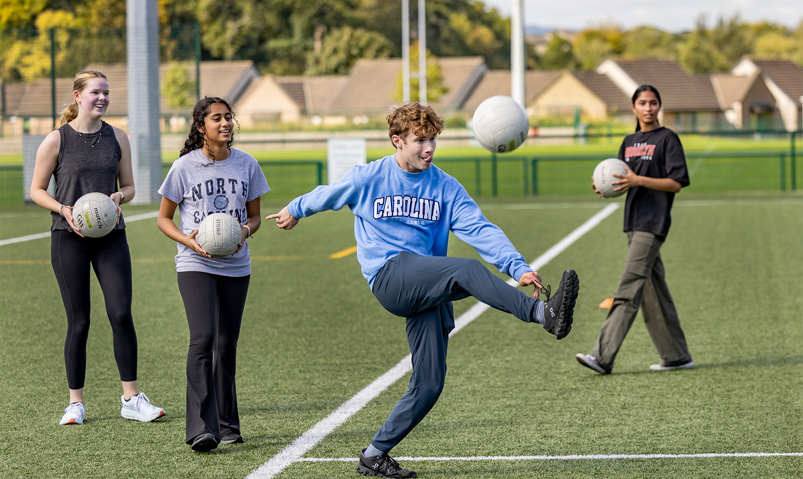 A student kicking a ball.