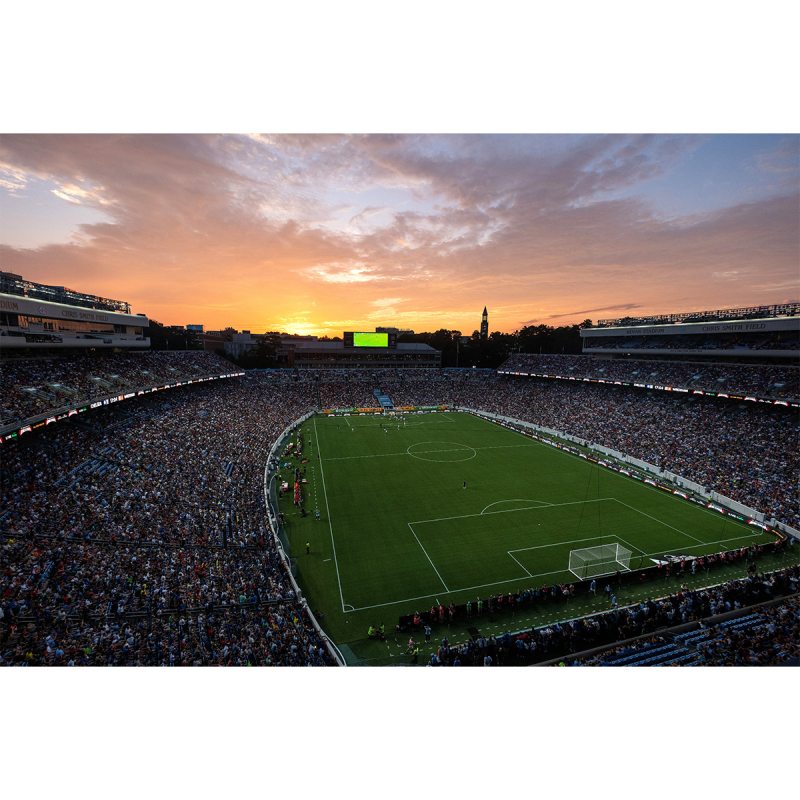 Kenan Stadium at sunset with a soccer game being played.
