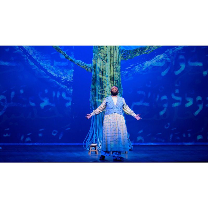 An actor playing the role of Omar Ibn Said and singing on stage in the opera 
