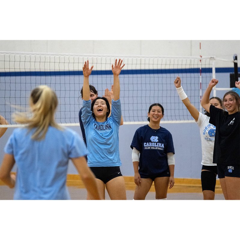 Club volleyball players celebrating during practice.