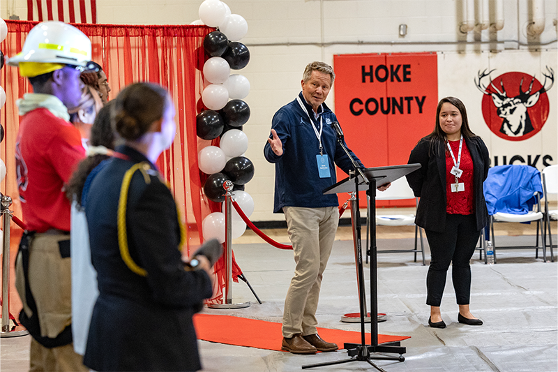 Chancellor Kevin M. Guskiewicz giving in a gymnasium at Hoke County High School.
