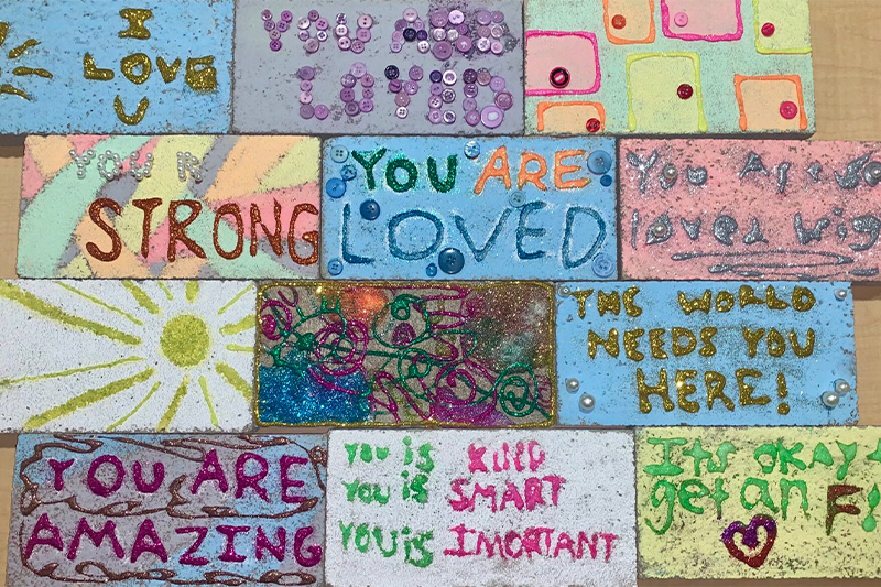 Painted bricks with various motivational messages written on them.