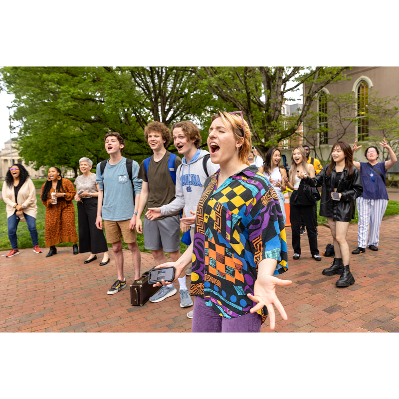 Students singing on Polk Place on the campus of UNC-Chapel Hill.