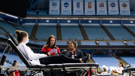 Woman getting blood taken while laying down inside of the Smith Center.