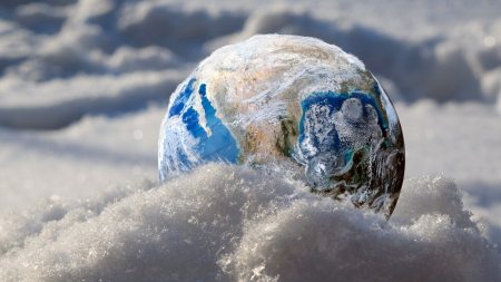 Earth sitting in a layer of snow.