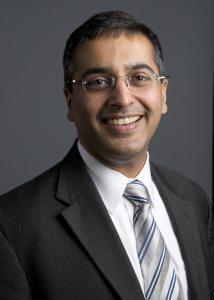 Dr. Abhi Mehrotra in a suit and tie