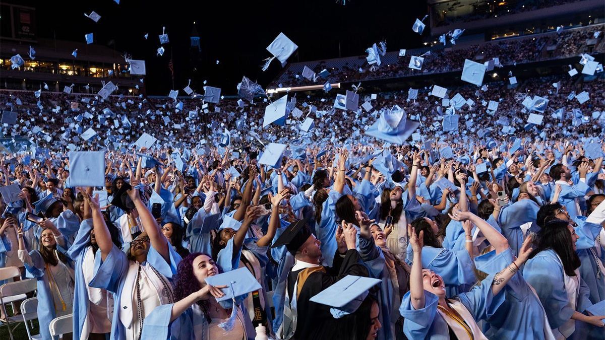 Students tossing caps at Commencement at Kenan Stadium