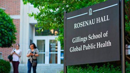 Exterior image of Rosenau Hall with sign in foreground reading 
